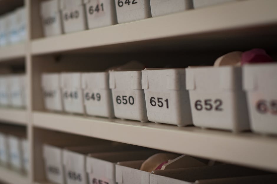 Close-up of numbered storage containers on shelves in an organized setting.